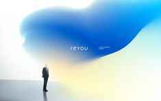 a man standing in front of a blue and white background with the words revu on it