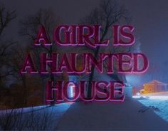 a neon sign that says a girl is a haunted house