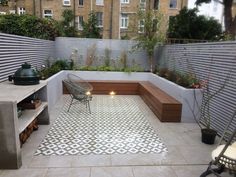 an outdoor patio with benches and potted plants