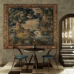 two chairs and a table in front of a painting on the wall with stairs leading up to it