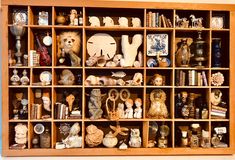 a wooden shelf filled with lots of different types of figurines