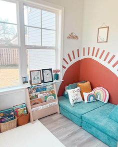 a living room with a couch, bookshelf and window