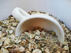 a bowl filled with granola sitting on top of a table