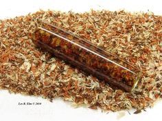 a wooden box filled with lots of wood shavings on top of a pile of dried