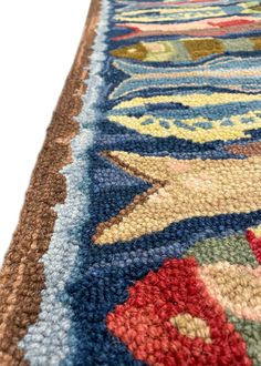 a multicolored area rug with various designs on the edges and colors that appear to be hand - knotted