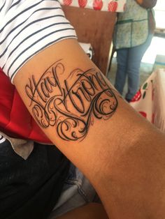 a person with a tattoo on their arm that says happy new year in cursive writing