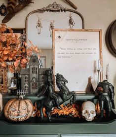 a green dresser topped with lots of halloween decorations