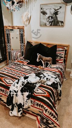 a bed room with a neatly made bed and animal decorations on the wall above it