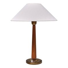 a wooden table lamp with a white shade on it's base and a gold metal base