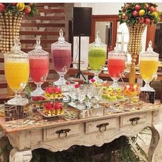 a table topped with lots of different types of drinks and desserts on top of it