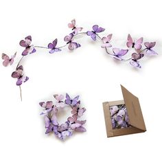 purple flowers are arranged around a cardboard box and some other things to make it look like they have been made out of paper