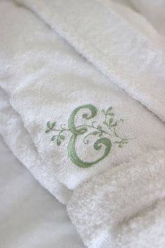 the towels are white with green designs on them