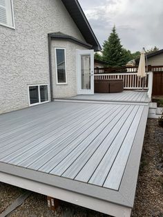 a large wooden deck in front of a house