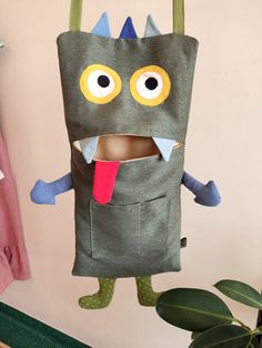 a paper bag with a monster sticking out of it's mouth