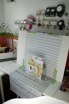 an open box sitting on top of a wooden table next to a white desk and chair