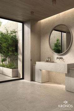 a bathroom with a sink, mirror and plants in the window sill next to it