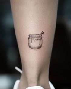 a woman's leg with a jar tattoo on her left side ribcage