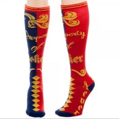 a pair of red socks with gold lettering on them and the words harry potter printed on it