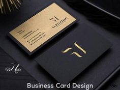 a black and gold business card sitting on top of a desk