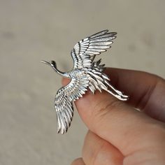 "This unique crane bird brooch is made of high-quality Sterling Silver and a perfect addition to your eccentric jewelry collection. Cranes are an important motif in Chinese mythology. In Chinese culture, the crane is venerated as the prince of all feathered creatures and thus has a legendary status. Embodying longevity, peace, wisdom, and nobility, it is the second most favored bird symbol after the phoenix. Throughout the imperial times, crane motifs were used on the robes of civil officials to Bird Sweater, Origami Necklace, Tiny Elephant, Chinese Mythology, Silver Bird, Crane Bird, Brooch Handmade, Elephant Pendant, Art Nouveau Jewelry