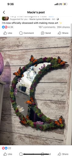 an image of a wreath made out of flowers and butterflies on the side of a wooden wall