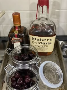 the ingredients for making an apple cider are shown in glass jars and on a metal tray