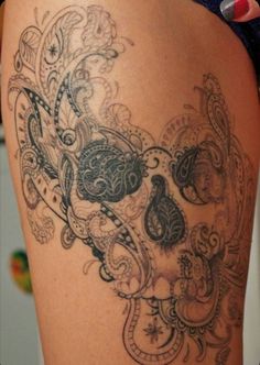 a woman's thigh with an intricate tattoo design on the thighs and back side