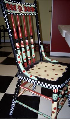 a chair that has some red and black umbrellas on it's back legs