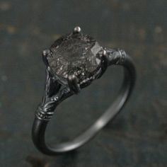 a close up of a ring with a stone in the middle and an arrow on it