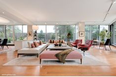 a living room filled with furniture and lots of windows