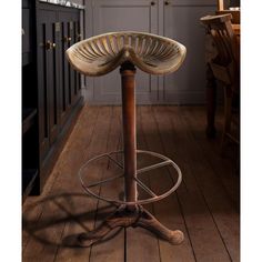 a wooden stool sitting on top of a hard wood floor