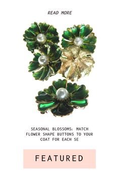 two green flower brooches with pearls on them