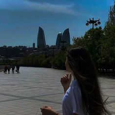 a woman is flying a kite in the sky