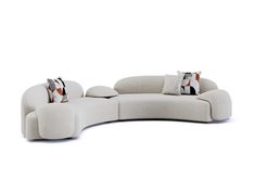 a curved couch with pillows on it