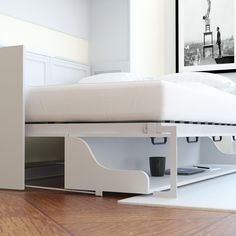 a bed that is sitting on top of a wooden floor