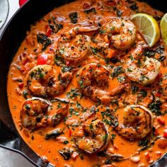 a skillet filled with shrimp and tomato sauce