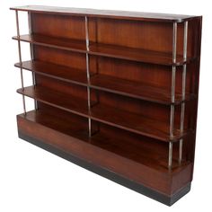 a wooden book shelf with four shelves on one side and three metal bars on the other