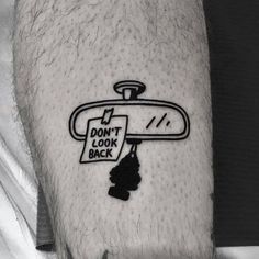 a black and white photo of a man's arm with a don't look back sign on it