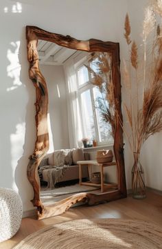 a large mirror sitting on top of a wooden floor