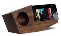 an iphone is sitting on top of a wooden speaker system that's built into the side of a wood stand