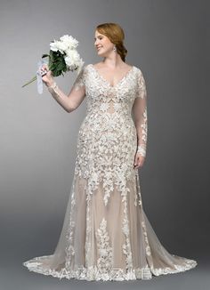 a woman in a wedding dress holding flowers