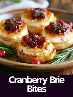 cranberry brie bites on a plate with rosemary