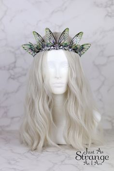 This is a must-have for all fairies! Here we have a beautiful tiara, fit for any fairy queen! This enchanting crown is comprised entirely of my handmade bright green fairy wings. The wings are attached a metal silver band, and adorned with clear gemstones. The wings are lightweight and far more durable than their glassy appearance might suggest! One size ought to fit all, but do message me if you are unsure. This tiara is best suited to adults over children, due to small parts. This is definitely a head turner! This beautiful crown is absolutely perfect for any fairy costumes and cosplays, Pagan or Wiccan events, weddings, proms - or even everyday wear. This would make the perfect addition to your festival outfit, bridal attire, renaissance costume ... the possibilities are truly endless. Green Fairy Wings, Faerie Costume, Clear Gemstones, Fairy Headpiece, Festival Crown, Fairy Costumes, Fairy Halloween Costumes, Fairy Festival, Fairy Outfit