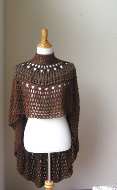 a mannequin wearing a brown crocheted sweater