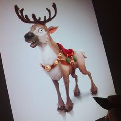 a hand holding a pen and drawing a reindeer