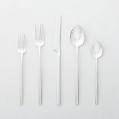 four forks, two spoons and one knife on a white surface