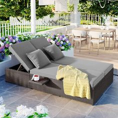 an outdoor daybed with pillows and blankets on it