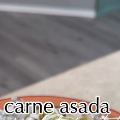 an orange and white plate with some food on top of it that says carne asada