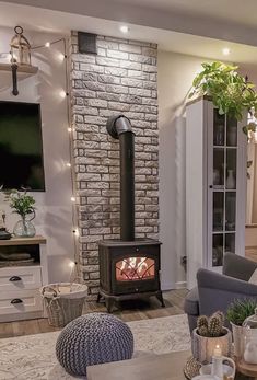 a living room filled with furniture and a fire place next to a tv mounted on a wall