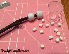 marshmallows are laid out on a pink cutting board